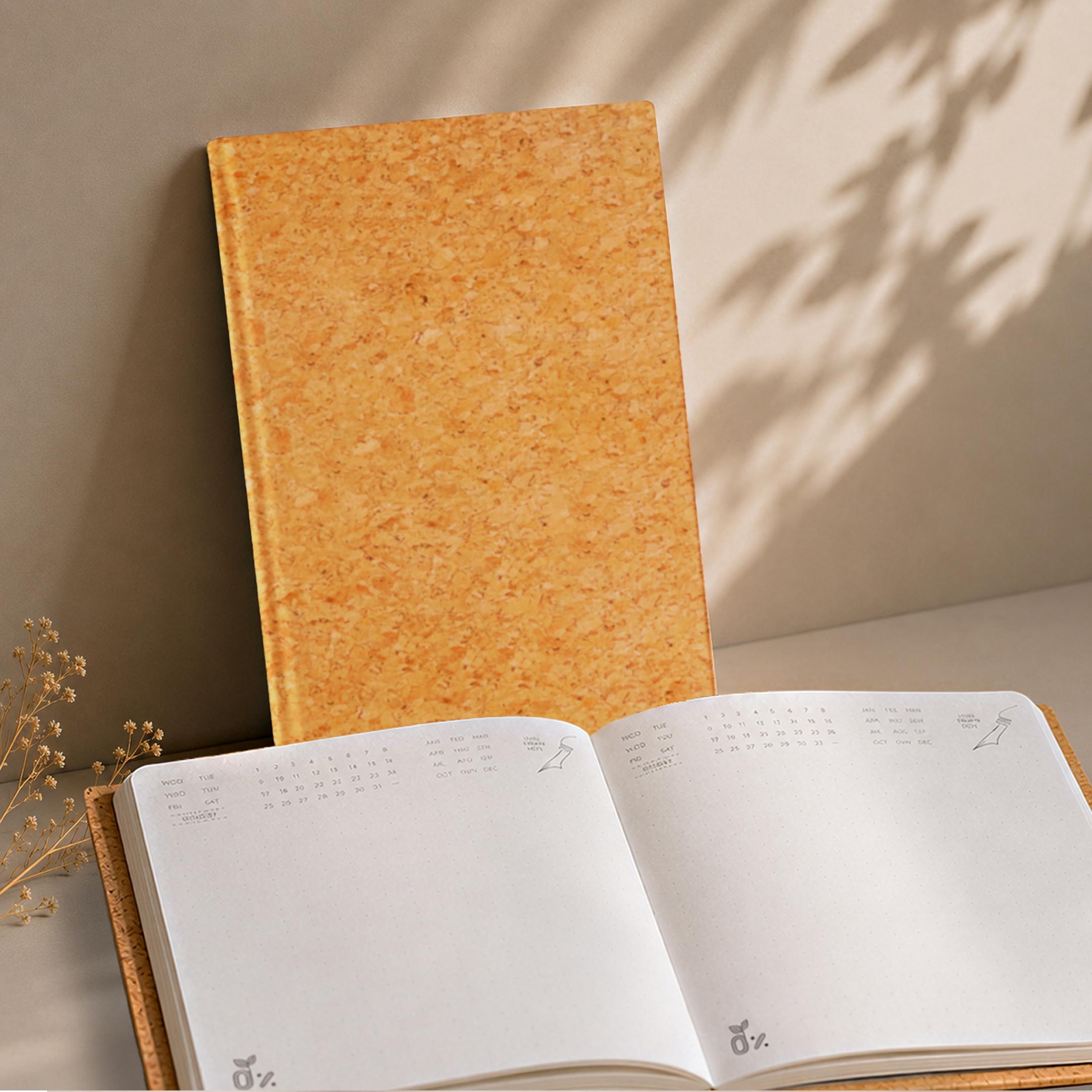 Minimalist cork-covered journals with a pen and succulent